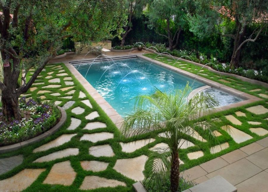 Fountains can add both sound and design to a pool, turning it into a large water feature for the yard.