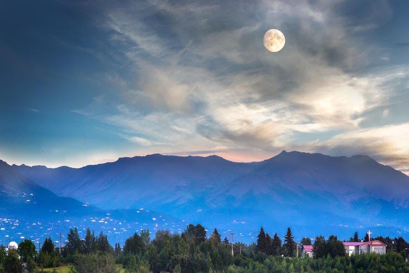 Full moon and mountains near by the Port Of Anchorage in Alaska, USA