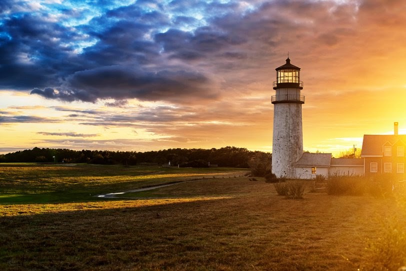 The Highland Lighthouse against a beautiful sunset in North Truro Massachusetts on the Cape Cod National Seashore