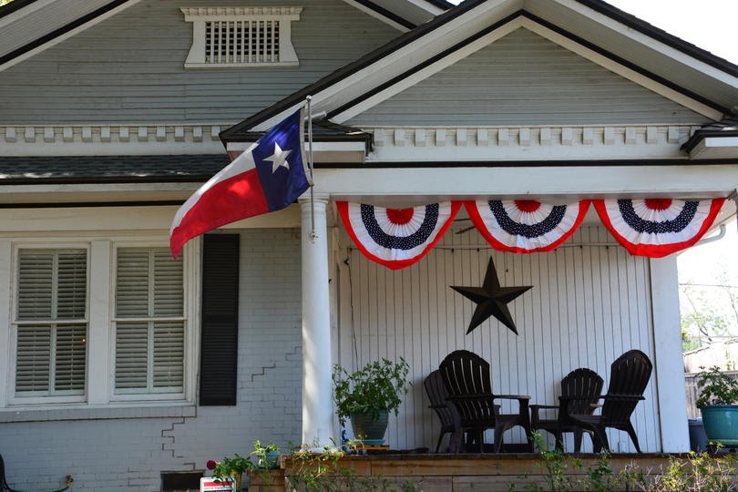 The Texas flag flys from the front porch of an arts and crafts home in the Dallas neighborhood of Lower Greenville