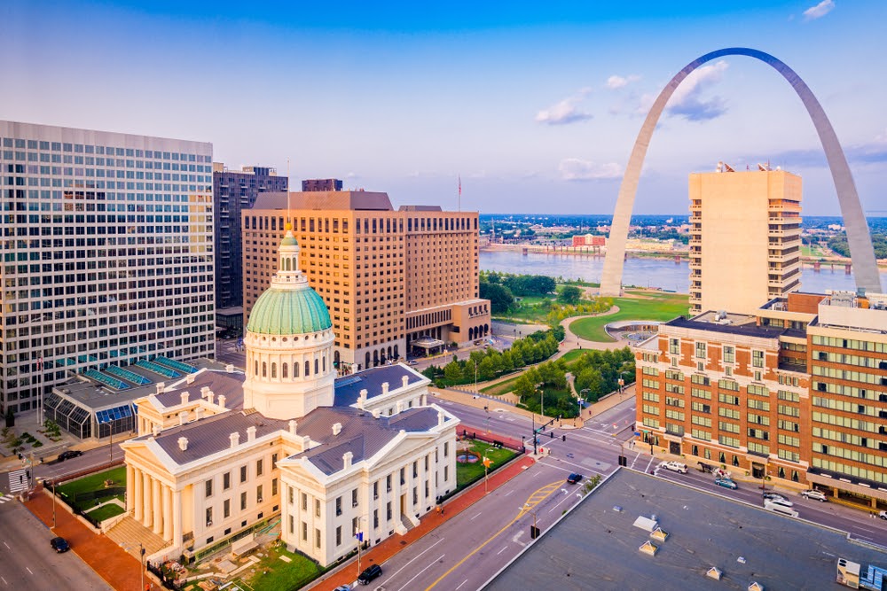 St. Louis, Missouri, USA downtown cityscape with the arch and courthouse at dusk.