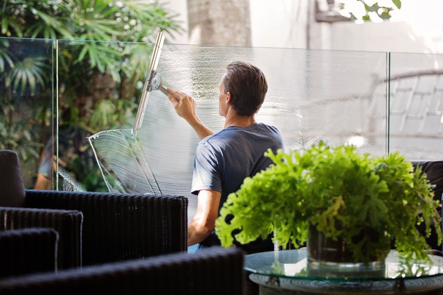 man cleaning glass windows
